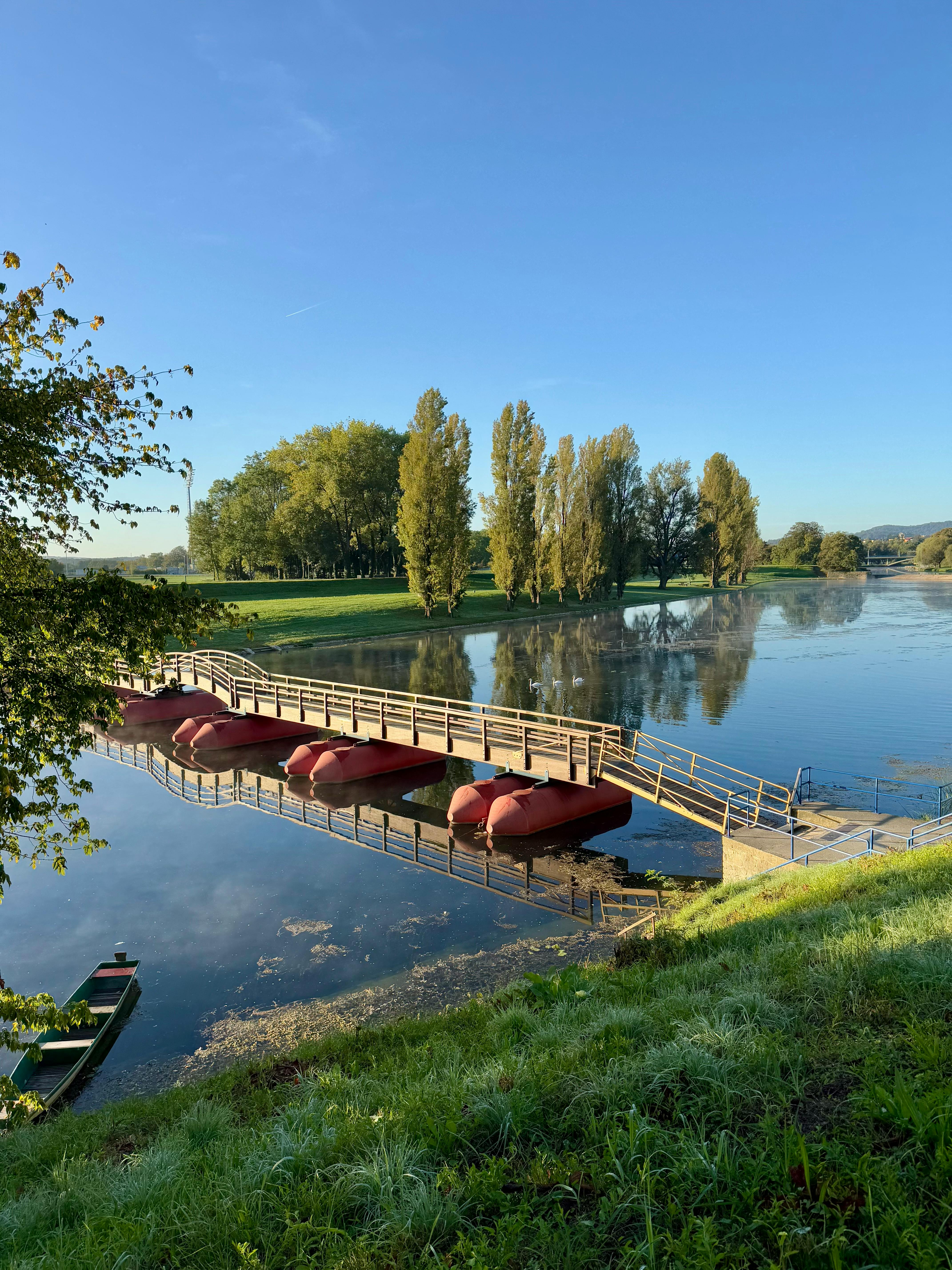 Karlovac four rivers confluence at golden hour with Kupa, Korana, Mrežnica, Dobra waters merging, historic star-shaped fortress, and lush green banks in central Croatia