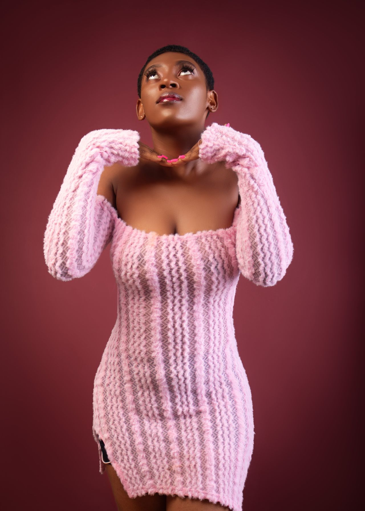 Woman wearing a pink knit sweater dress