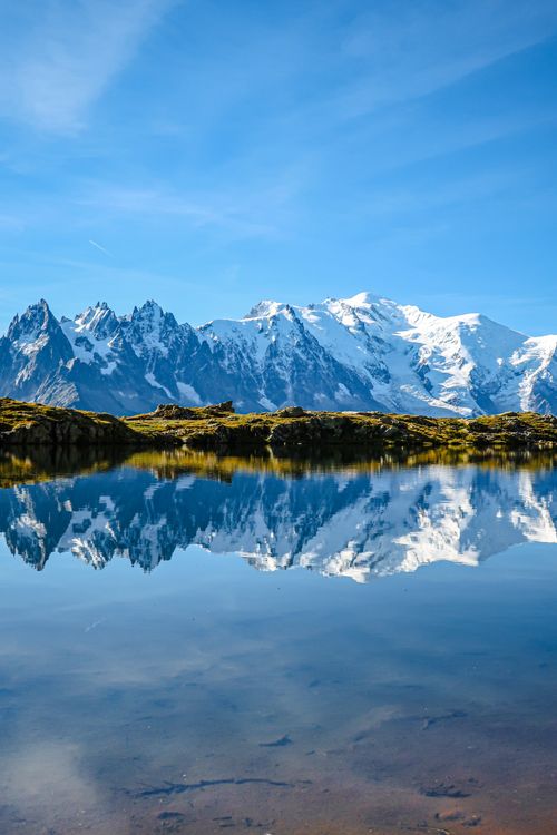 Free Captivating reflection of Mont Blanc mountains in a serene lake in Chamonix, France. Stock Photo