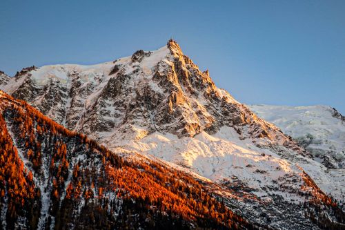 Free A stunning view of Aiguille du Midi bathed in golden hour light, Chamonix, France. Stock Photo