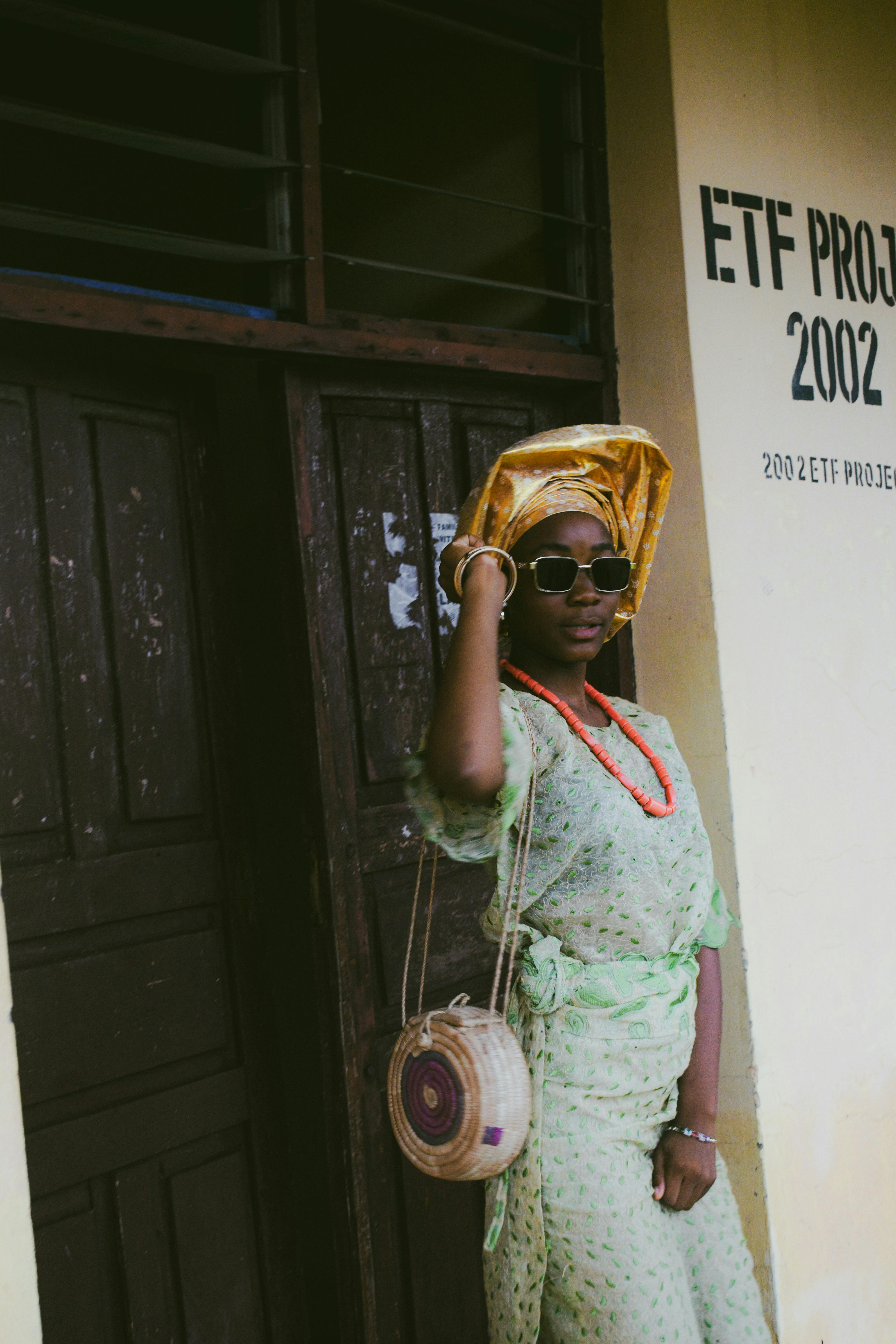 Free African woman in traditional attire with colorful headwrap and accessories. Stock Photo