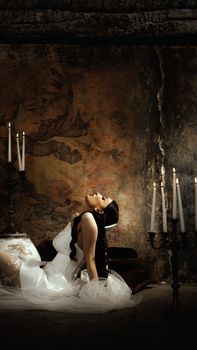 Artistic bridal portrait with vintage decor, candles, and elegant composition.