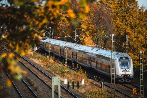 Free Train traversing colorful autumn scenery in Bielefeld, surrounded by vibrant fall foliage. Stock Photo