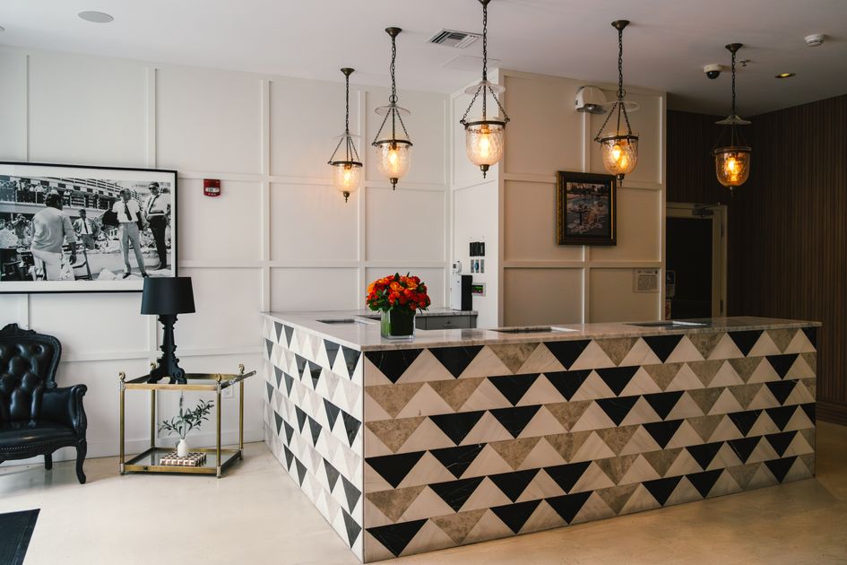 Explore the elegant reception area of a Miami Beach boutique hotel, showcasing modern coastal design and vibrant decor. Related image for AI in hospitality in Global hotels.