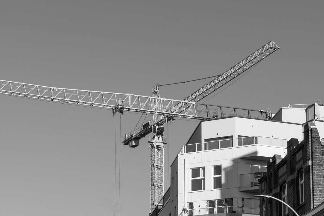 Black and White Crane Over Building in Liège · Free Stock Photo
