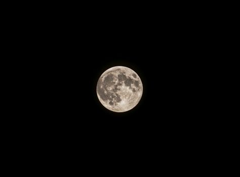 A captivating full moon against a black night sky captured in detail.