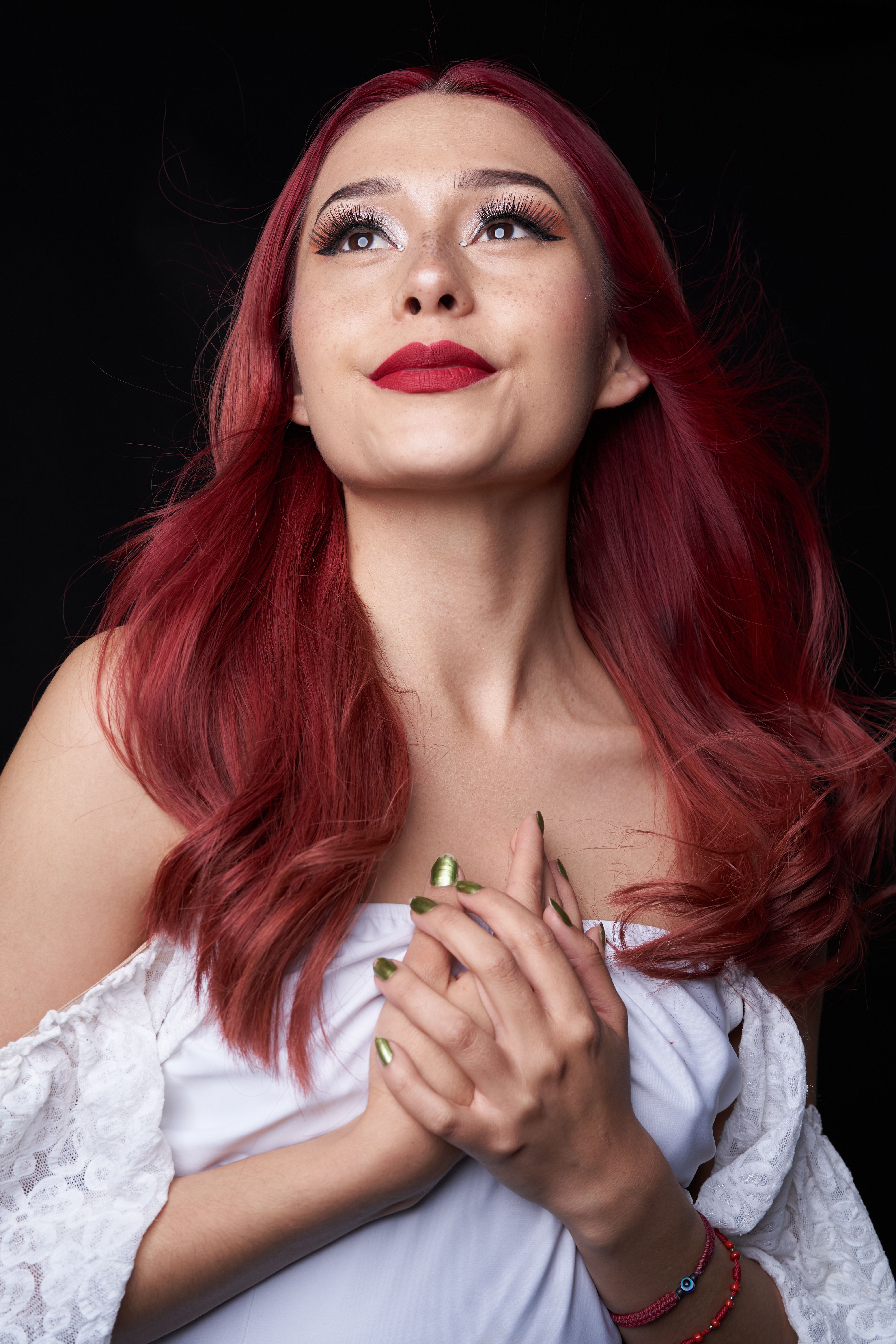 Portrait of a Woman with Red Hair in Thoughtful Pose · Free Stock Photo
