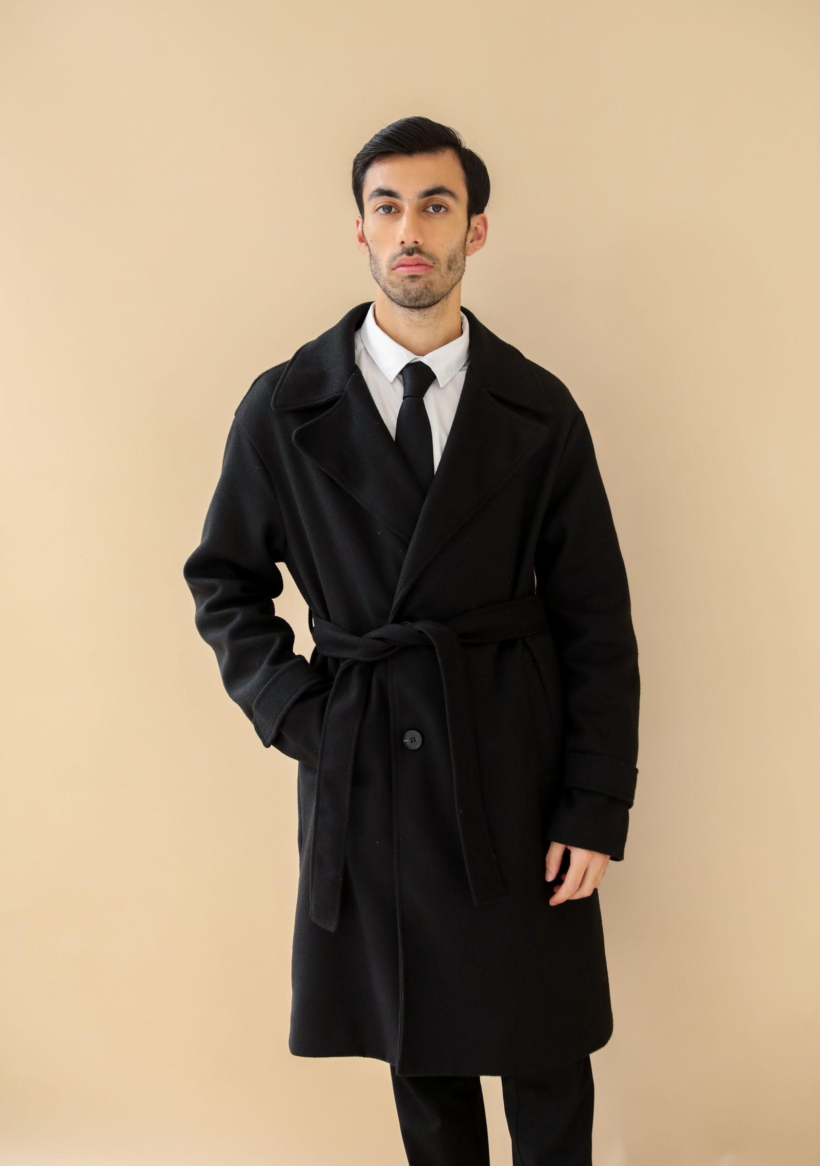 Model in a heavyweight overcoat from the AW26 Forge Line collection