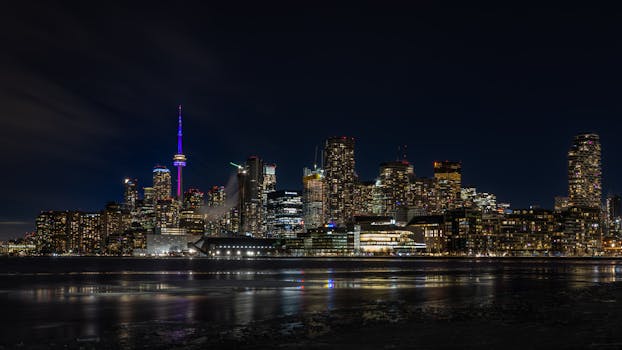 Dazzling night view of the Toronto skyline with the iconic CN Tower illuminated.