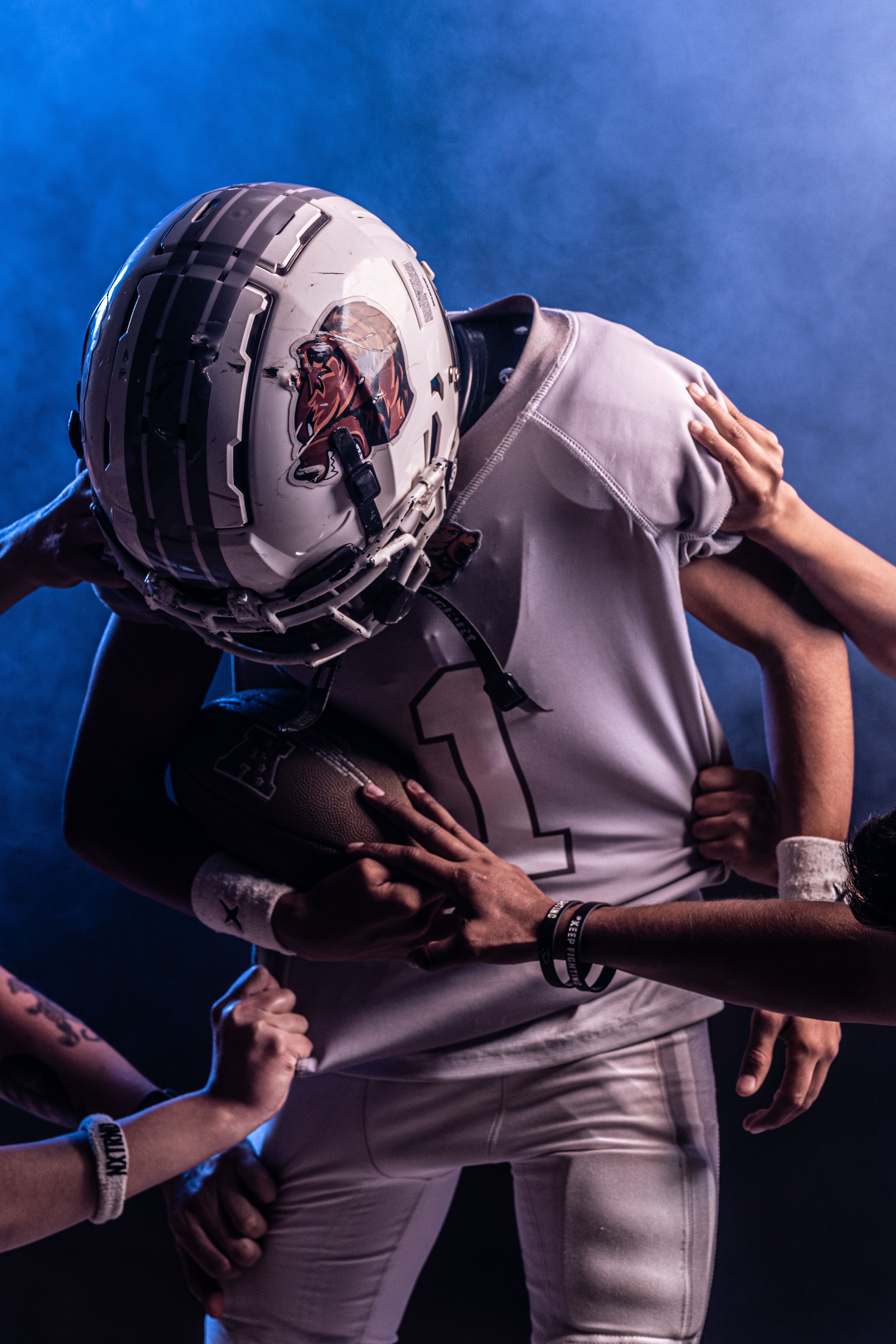 Dramatic Football Tackle Under Stadium Lights · Free Stock Photo