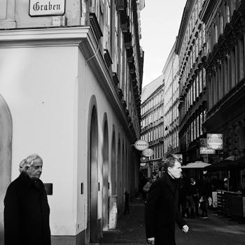 Black and white photo capturing bustling street life on Graben in central Vienna, Austria.