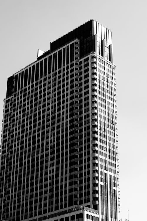 Free Black and white image of a tall modern skyscraper in Mexico City, capturing urban architecture. Stock Photo