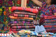 Vibrant handwoven textiles displayed at Sumpango market in Guatemala.