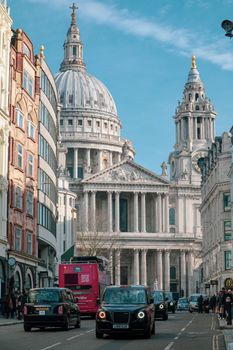 Vibrant city scene featuring St. Paul's Cathedral with iconic London taxis and architecture.