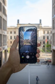 Photograph of Berlin architecture through a smartphone lens in dynamic street setting.