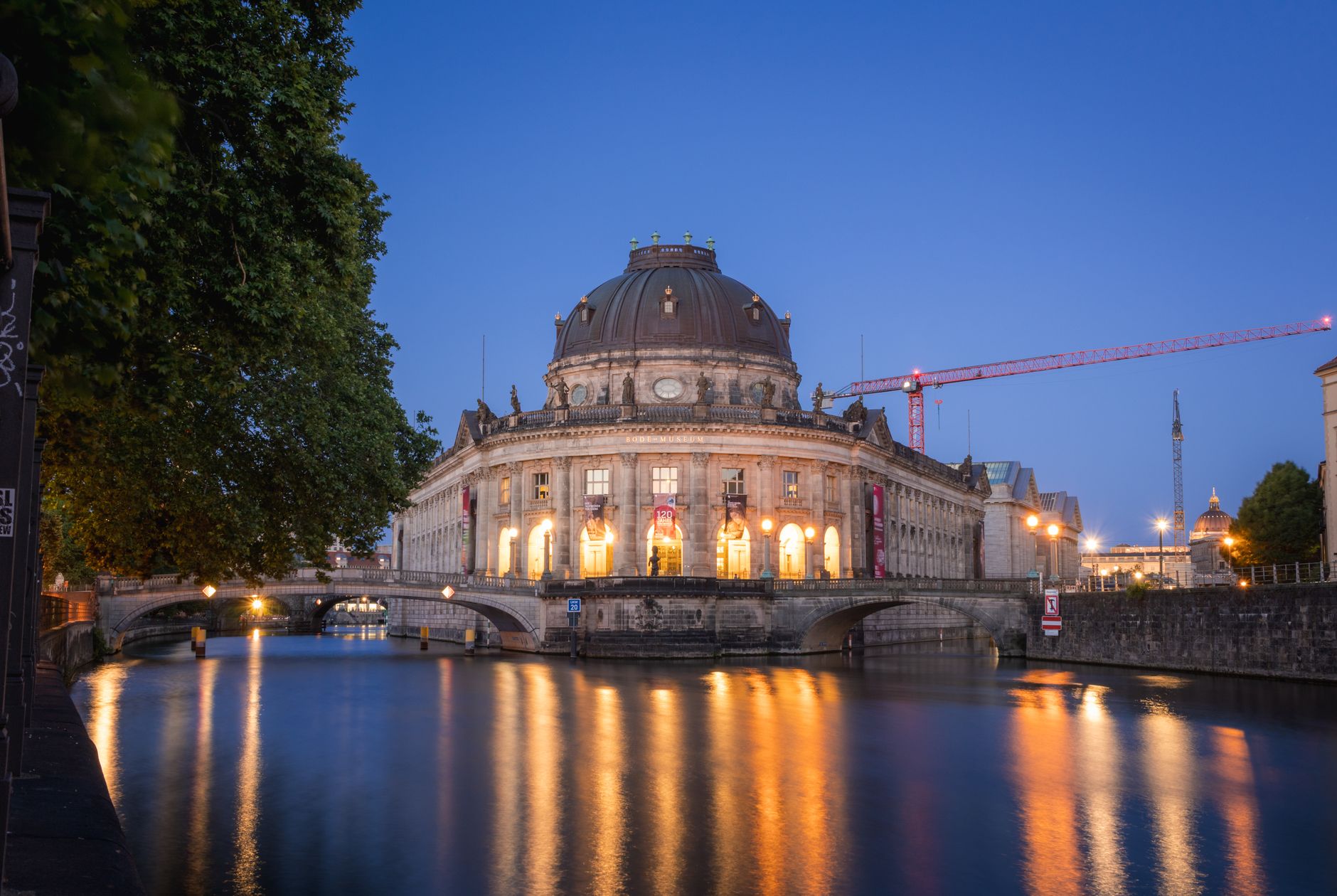 Twilight view of the Bode Museum reflecting in the Spree River, Berlin.