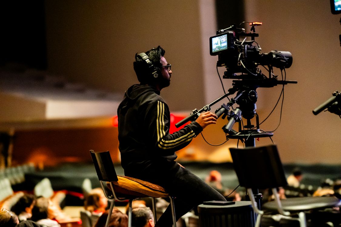 Cameraman Filming With Professional Equipment Indoors Free Stock Photo cameraman-filming-with-professional-equipment-indoors-free-stock-photo