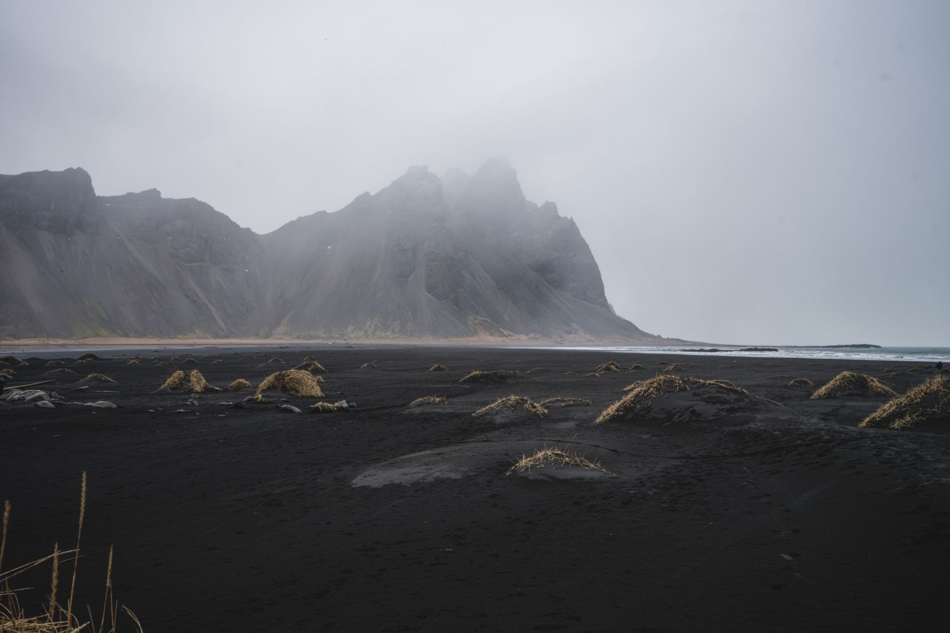 Black basalt beach with sea stacks