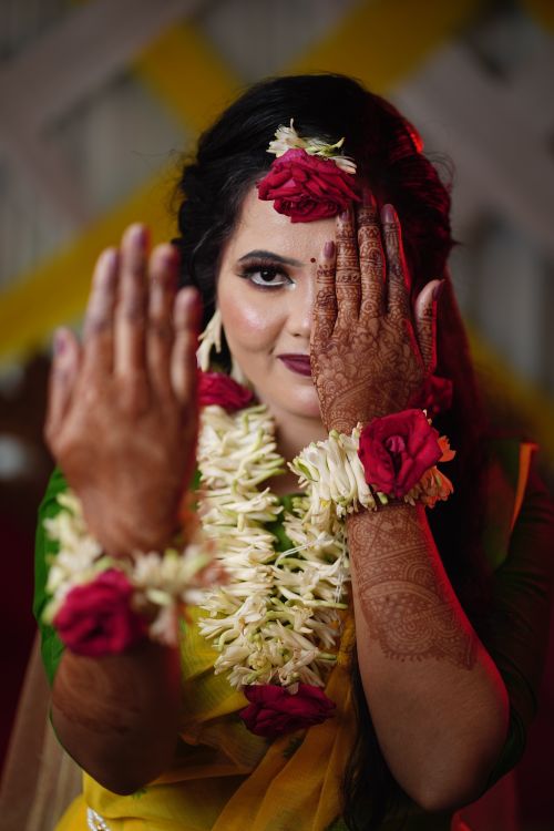 Free Close-up of a bride with floral adornments and henna, showcasing beauty and tradition. Stock Photo