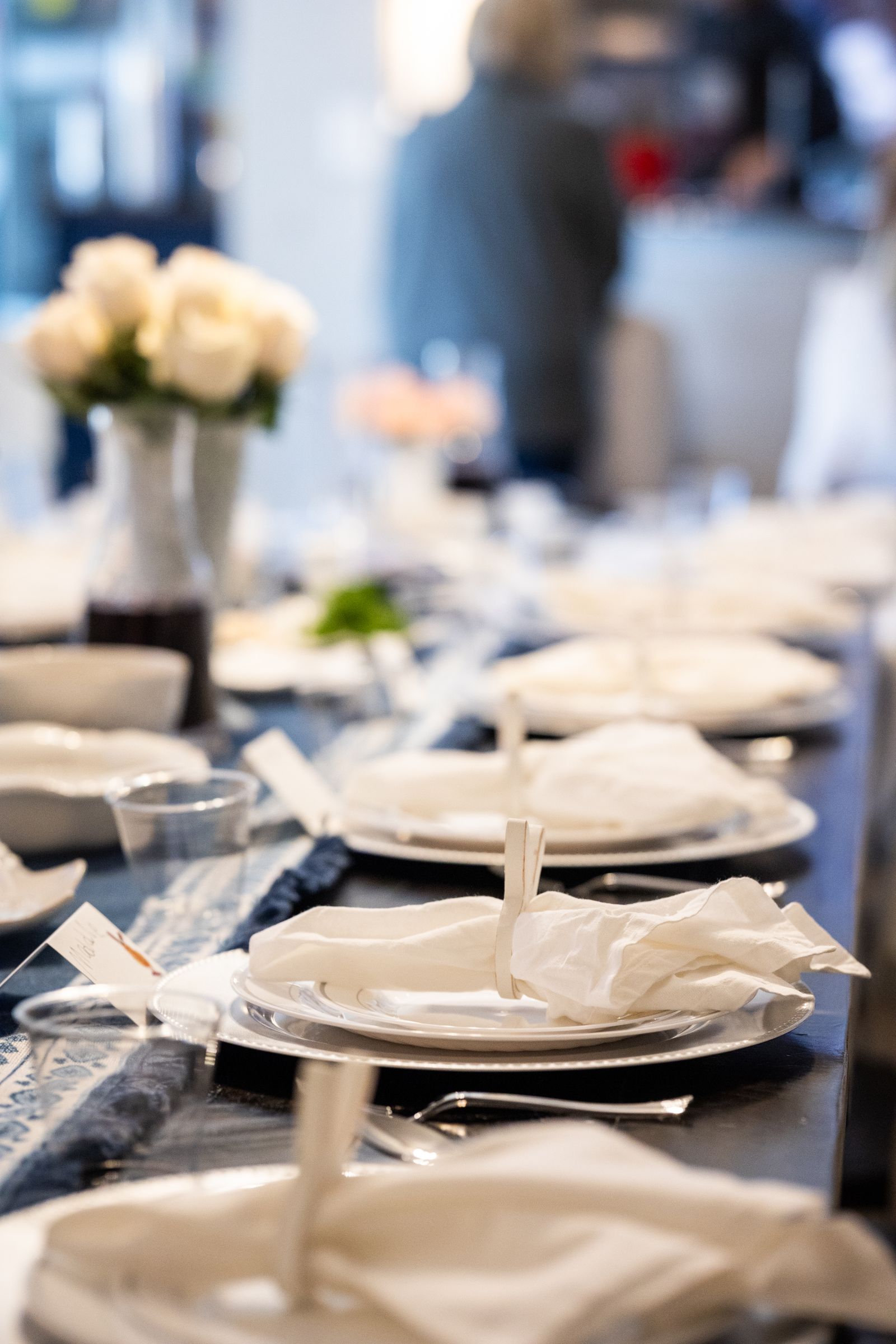 Elegant dining table setting with white roses and place settings
