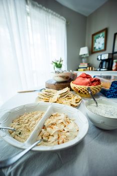 Indoor dining table set with dips and bread. Ideal for family gatherings or casual dining experiences.