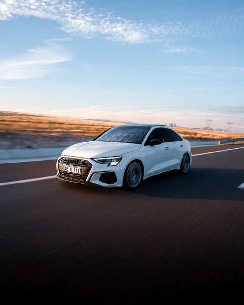 Free Modern white sedan driving on an empty highway in Ankara, Türkiye during a serene sunset. Stock Photo