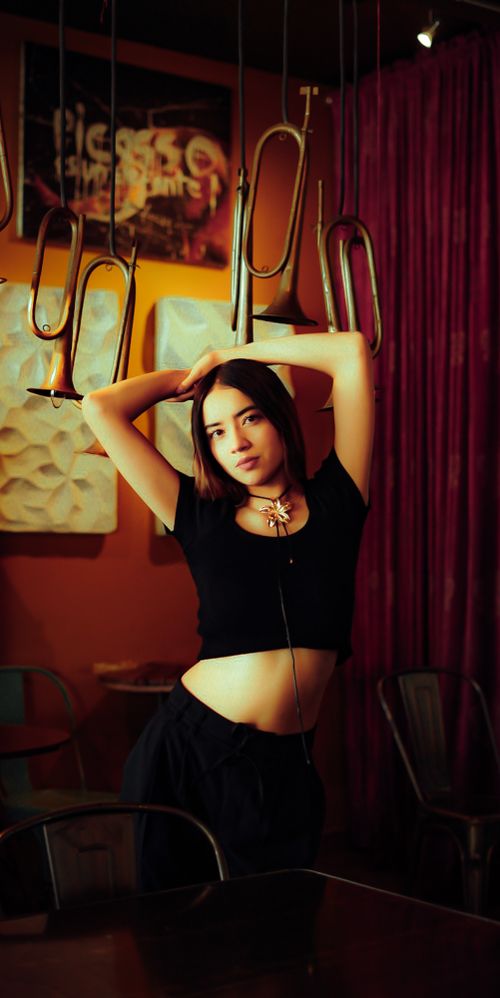 Stylish Woman Posing in Atmospheric Setting · Free Stock Photo