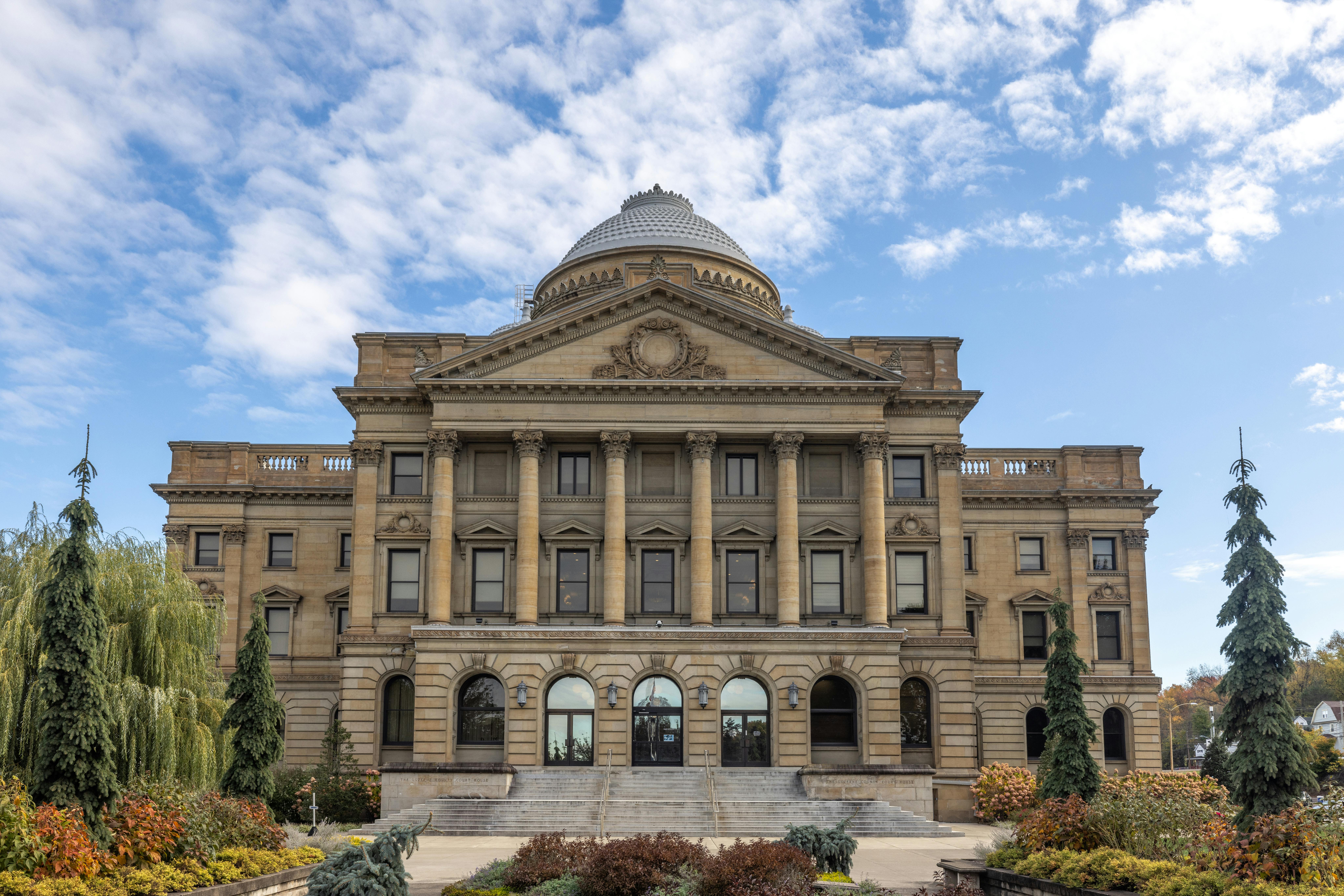 Front view of Luzerne County Courthouse, Wilkes-Barre, under a blue sky.