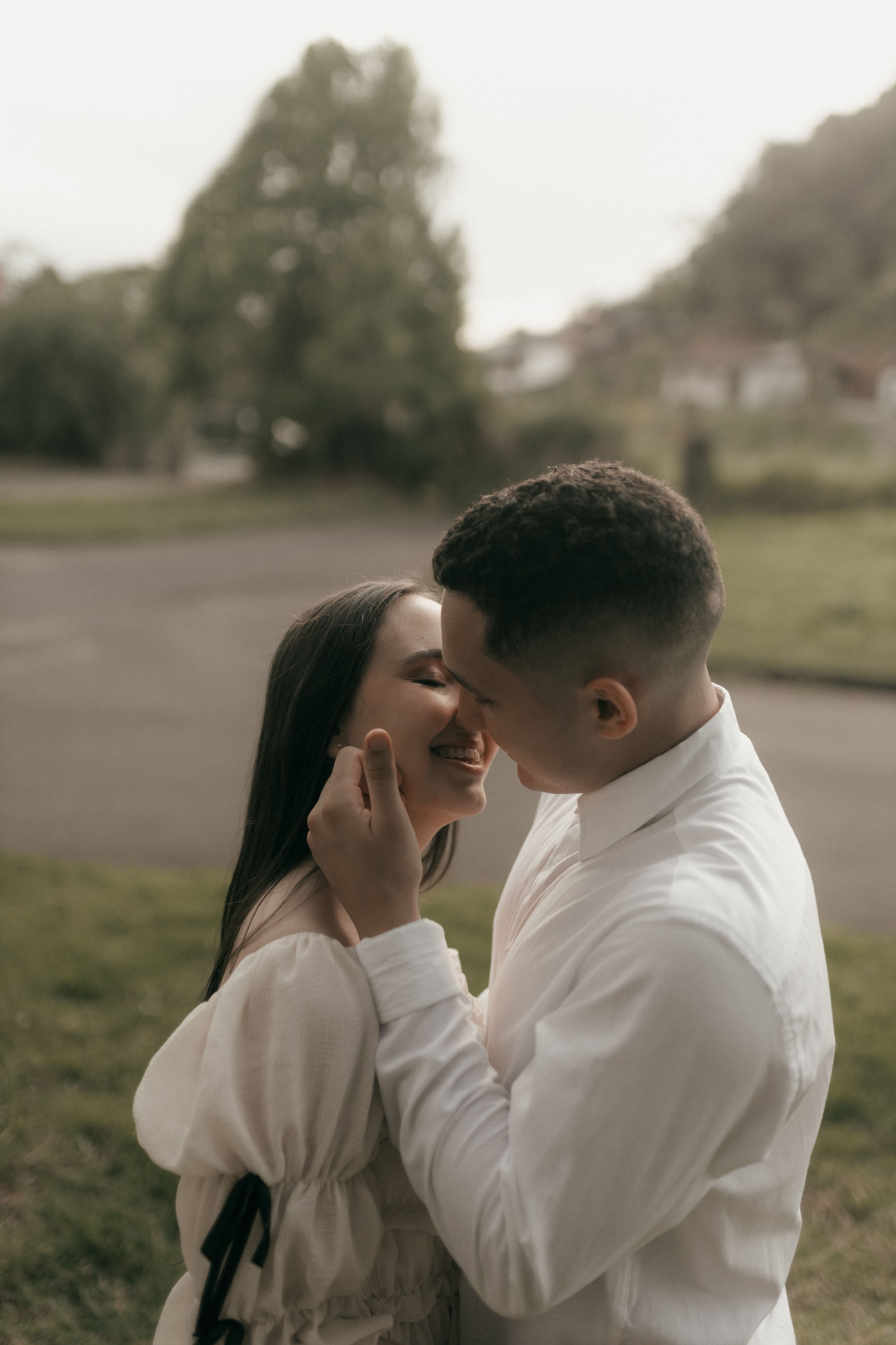 Romantic Couple Sharing a Tender Kiss Outdoors · Free Stock Photo