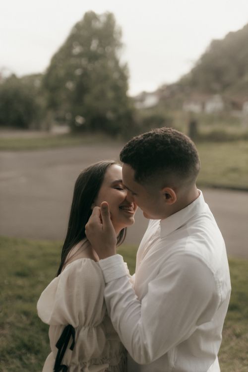 Romantic Couple Sharing a Tender Kiss Outdoors · Free Stock Photo