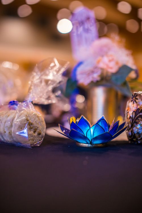 Free A beautifully decorated table with a blue lotus candle centerpiece creating a warm ambiance. Stock Photo