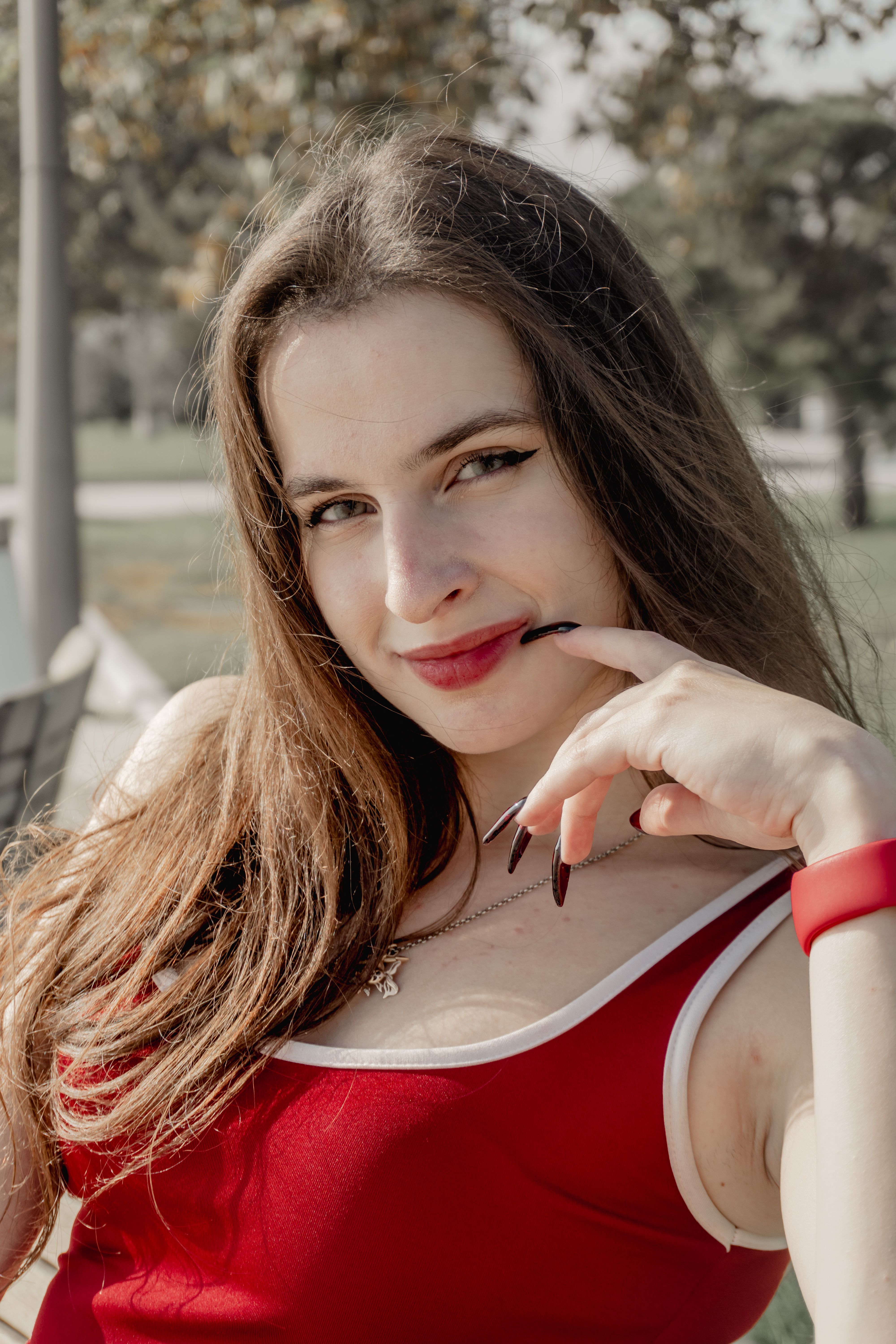 Smiling Woman in Red Top Outdoors · Free Stock Photo