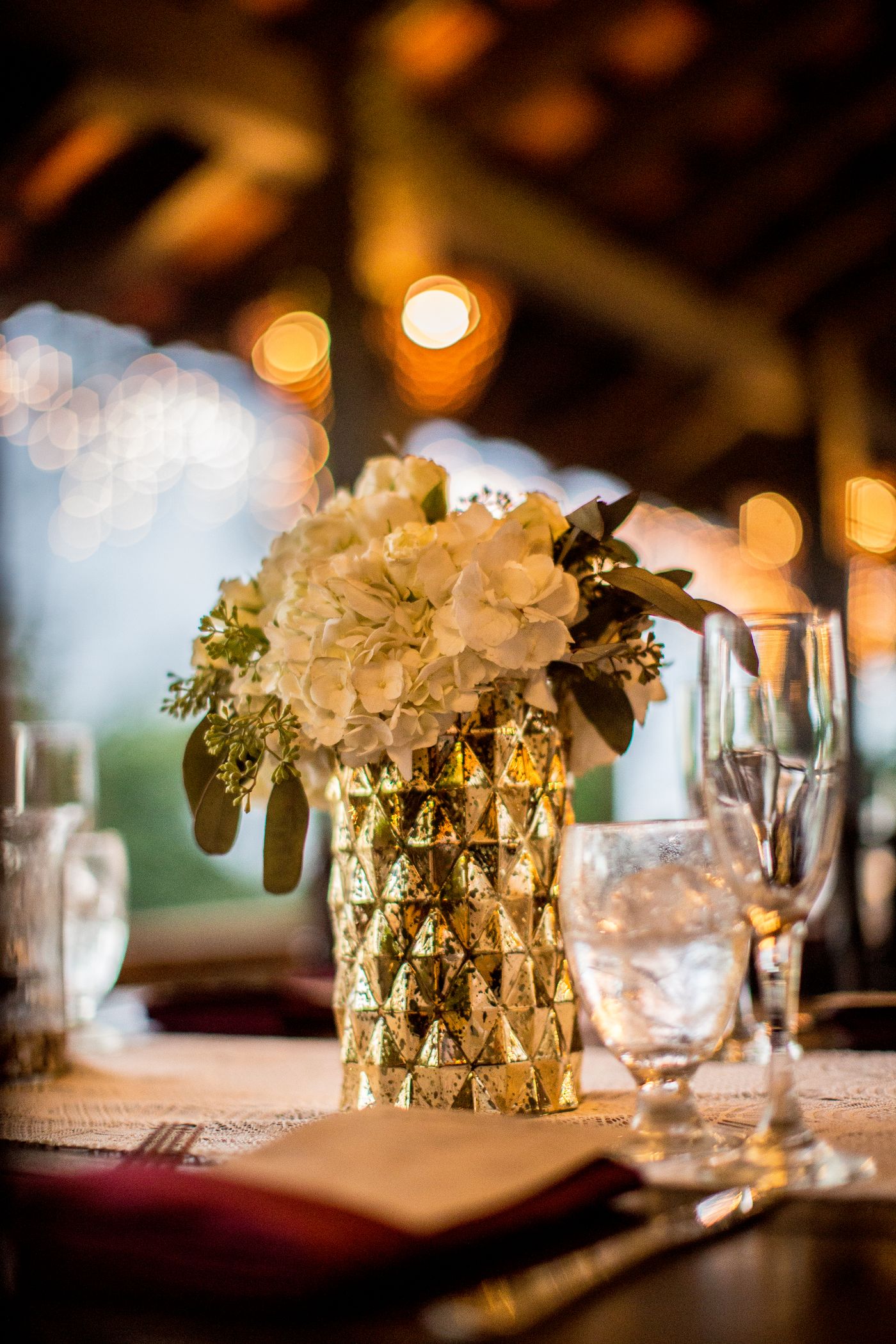 An elegant table set with a floral centerpiece and soft candlelight