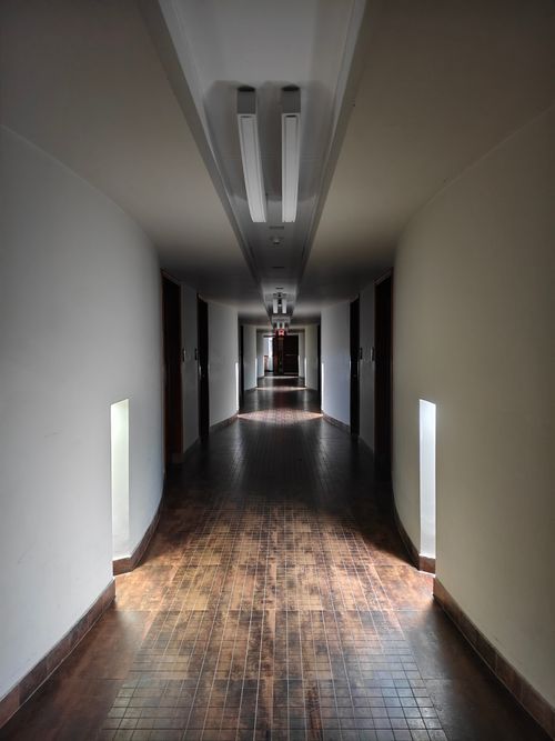 Free A wooden-floored corridor with soft lighting in a hotel at Cox's Bazar, Bangladesh. Stock Photo