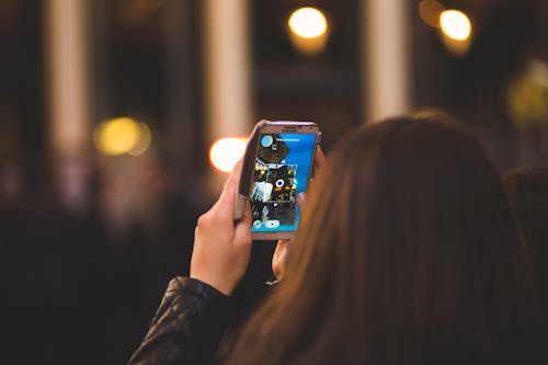 Woman Taking Photo Using Smartphone