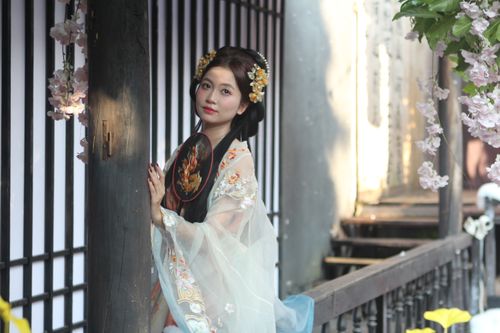 Free Woman in traditional Asian attire with floral accessories gazing thoughtfully. Stock Photo