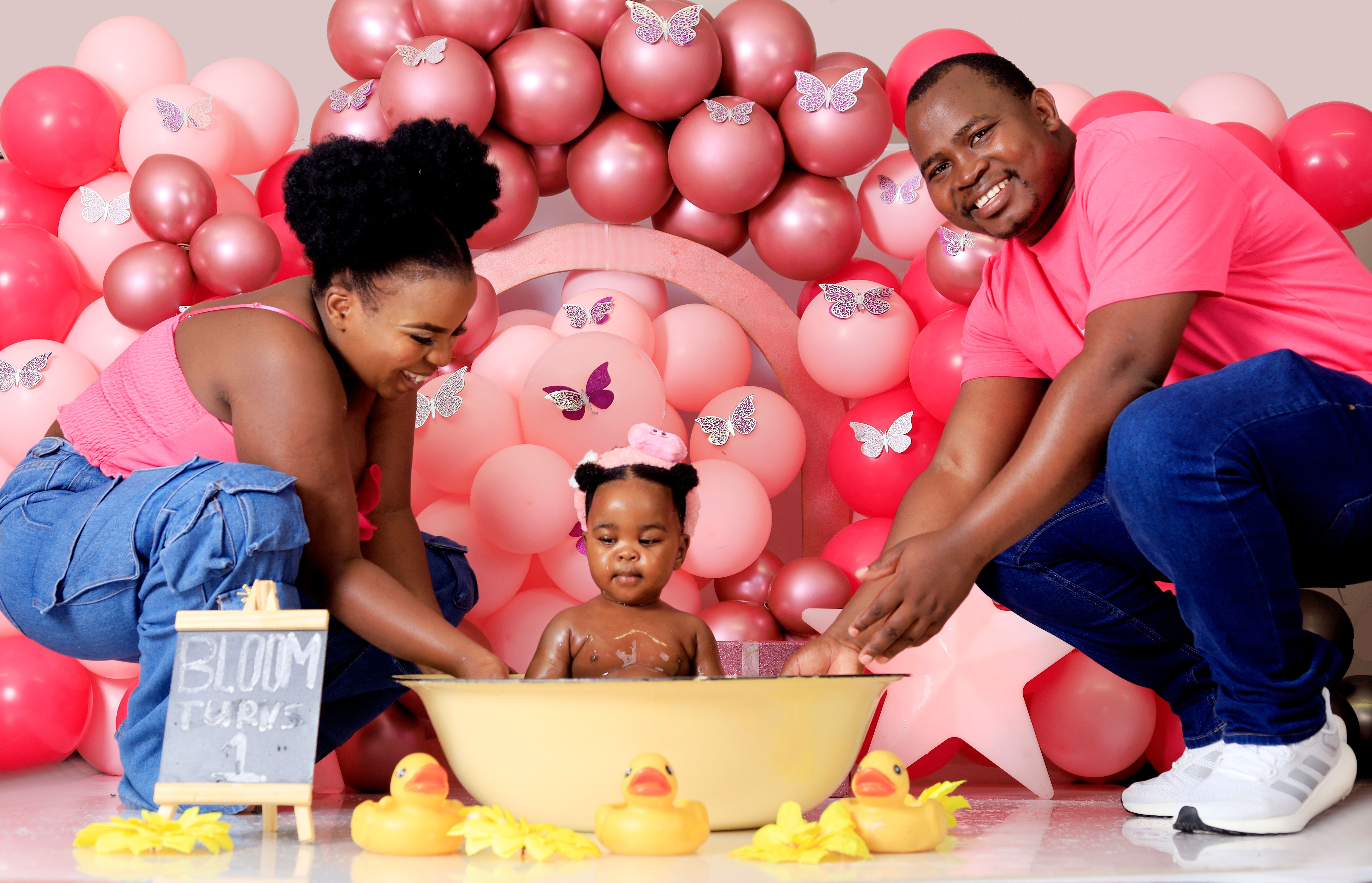 Adorable family birthday with balloons and bath fun.