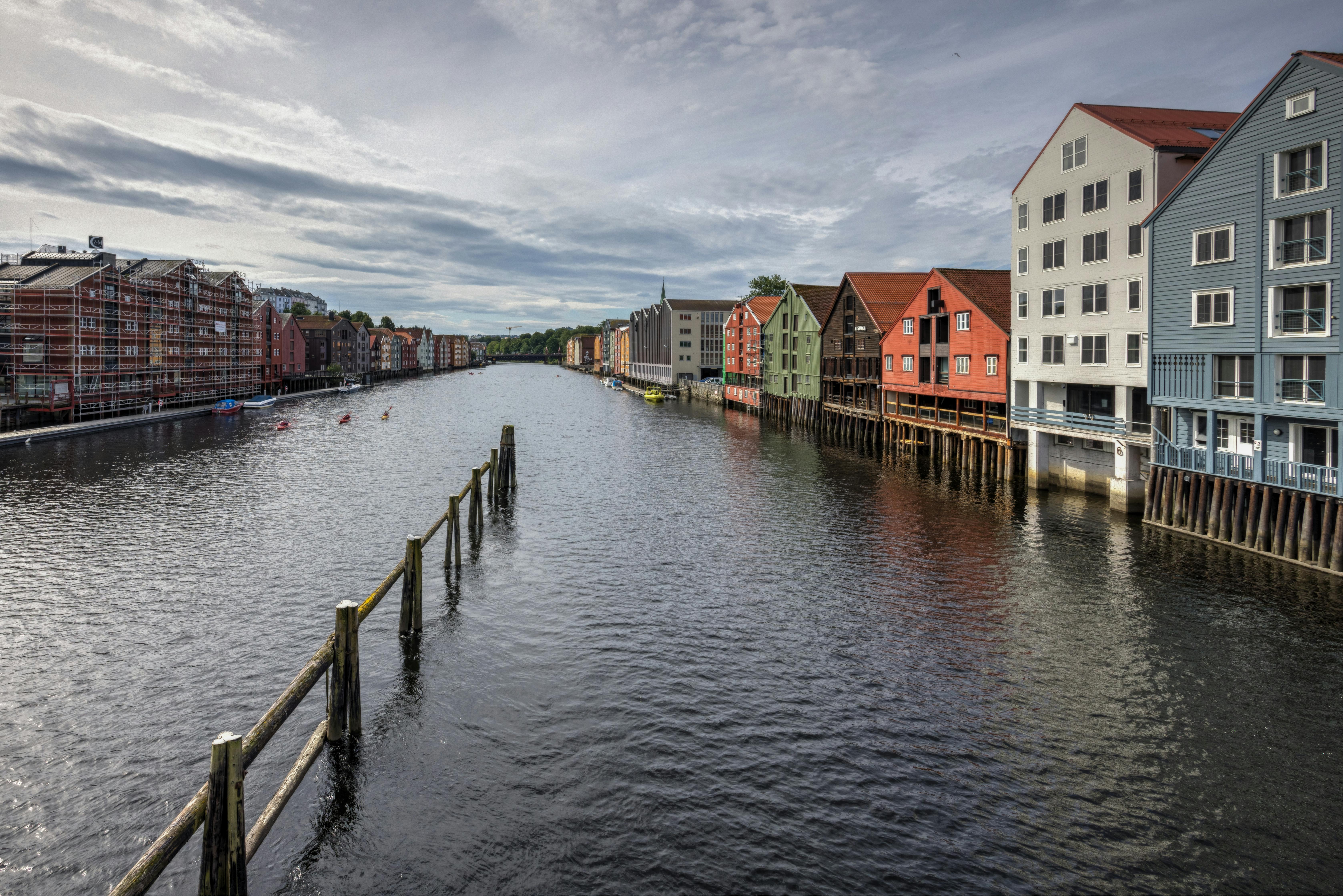 Charming waterfront scene of colorful buildings by the canal in Trondheim, Norway.