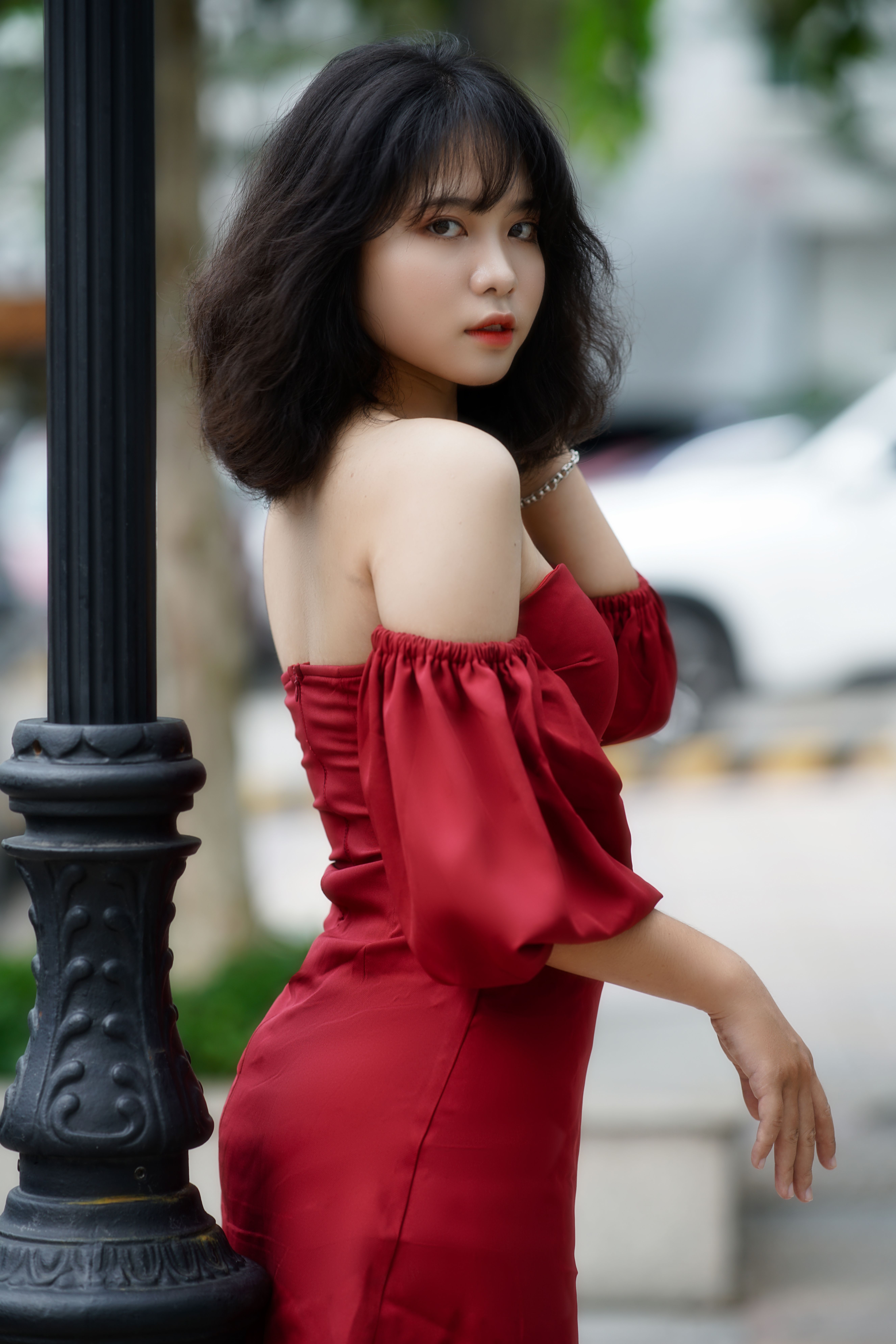 Elegant Woman in Red Dress Posing Outdoors · Free Stock Photo