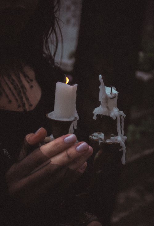 Free A close-up of hands holding candles, creating a moody ambiance. Stock Photo