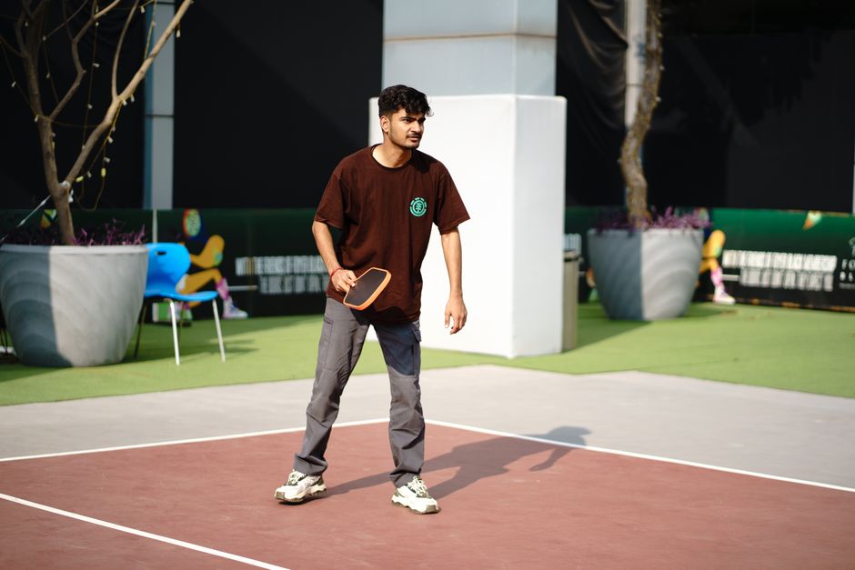 A pickleball player lunging deep on a court showing the stress placed on the shoe's outer edge - men's pickleball shoes A pickleball player lunging deep on a court showing the stress placed on the shoe's outer edge - men's pickleball shoes