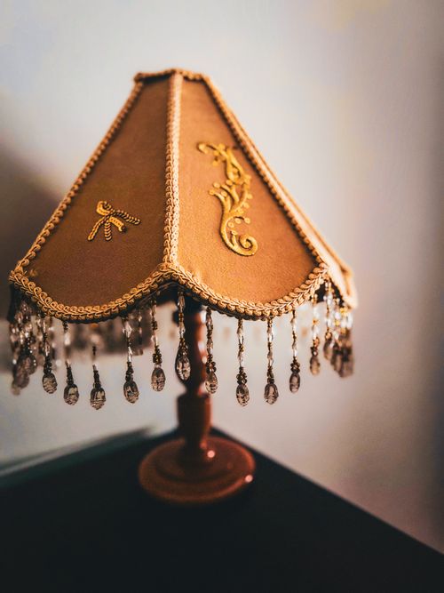 Free Charming vintage lamp with intricate beaded fringe and ornate embroidery design. Stock Photo