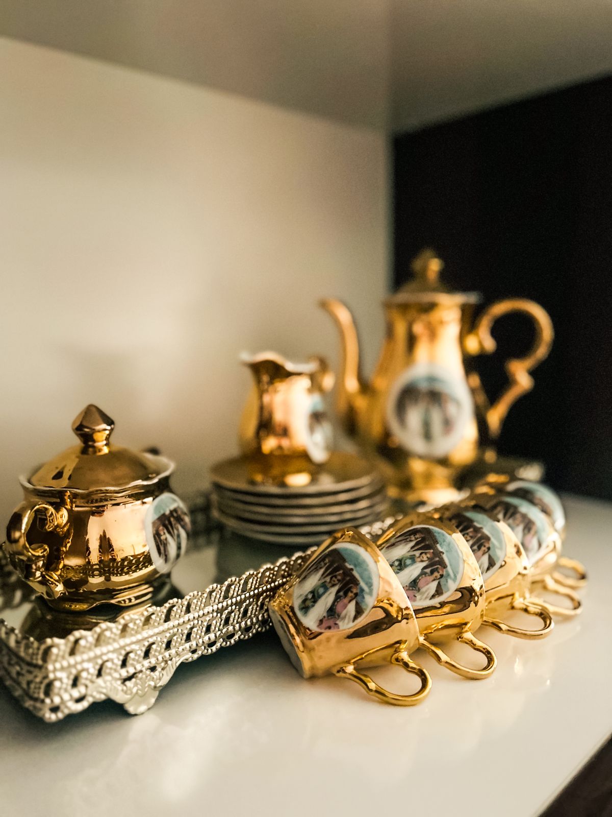 Elegant gold-plated tea set on an ornate tray — evoking Peninsula afternoon tea service