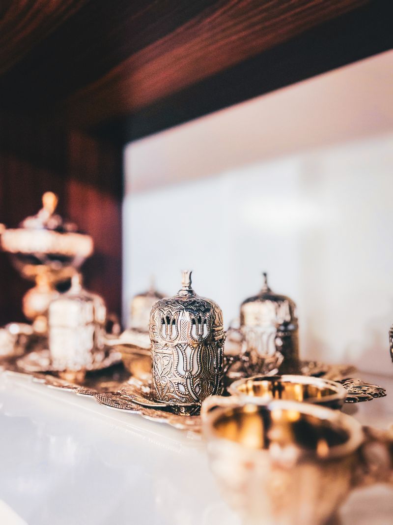 An ornate multi-piece silver tea set displayed on a tray, illustrating a complete service