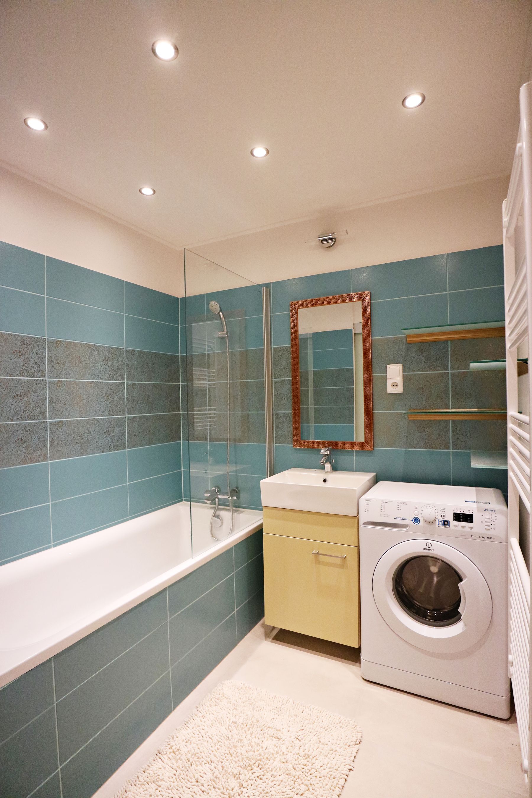 Green finish used at architectural scale around functional bathing and utility zones