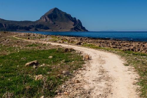 Free Explore a scenic coastal pathway with a stunning mountain and ocean view. Stock Photo