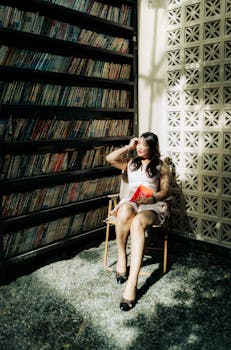 A woman sitting in a sunlit library corner, surrounded by bookshelves, exuding relaxation and contemplation.
