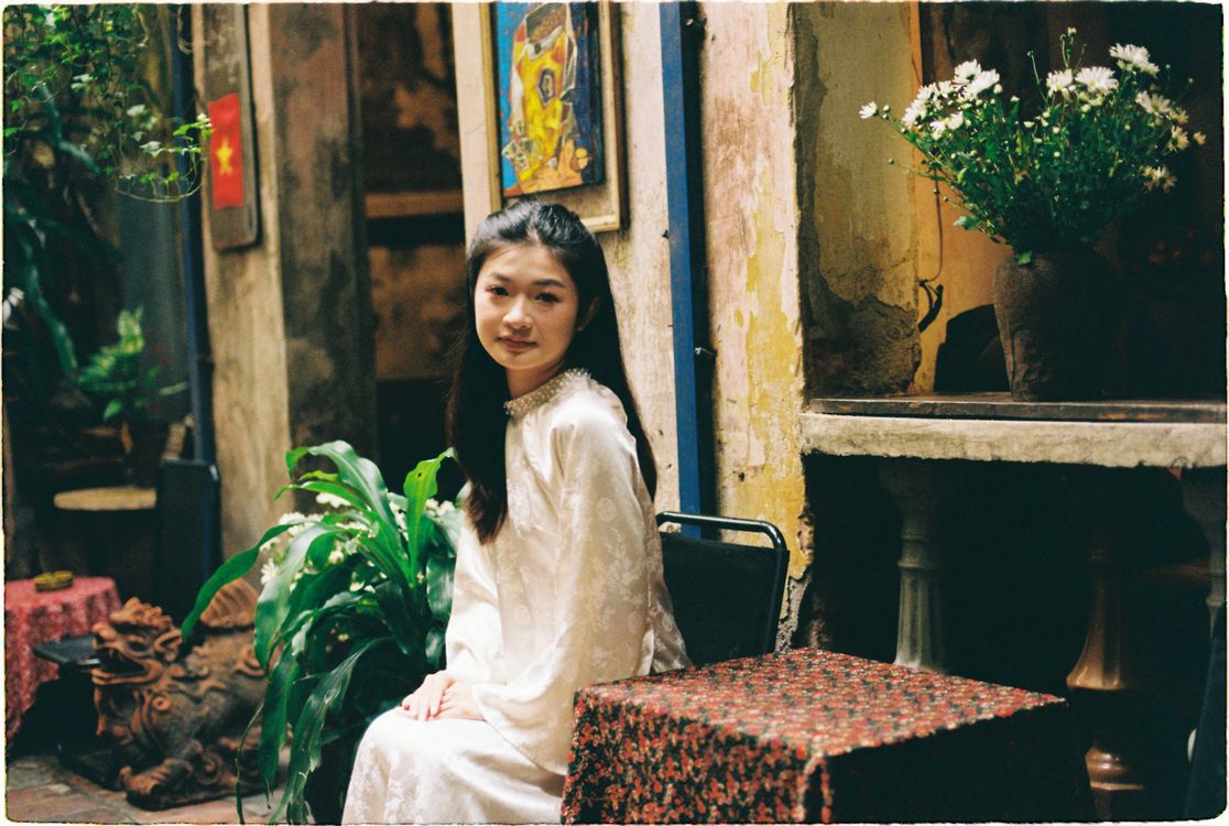Young Woman in Traditional Dress Sitting in Decorated Hallway · Free ...