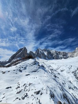 Breathtaking view of snowy mountains under a vibrant blue sky.