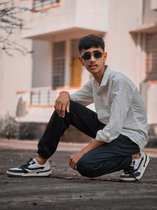 Free Stylish young man posing in sunglasses with urban background. Stock Photo